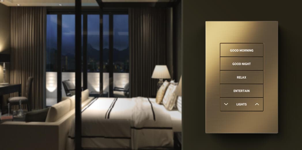 Brushed-brass Crestron Horizon keypad with scene buttons, beside a softly lit bedroom at dusk.