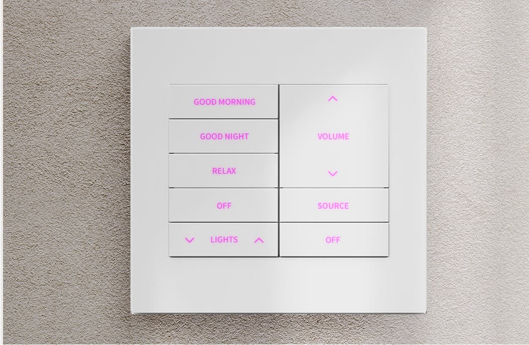 White Crestron Horizon keypad on a plaster wall, its scene and volume buttons backlit in magenta.